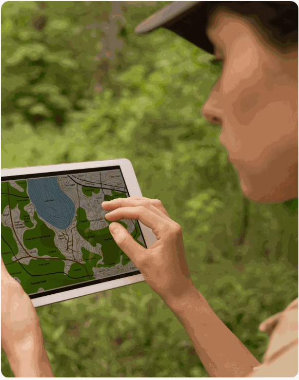 Field team mapping plantation plots on a tablet