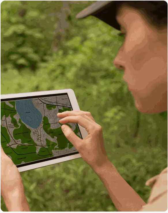 Field team mapping plantation plots on a tablet